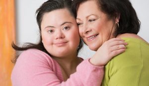 youth with down syndrome hugging mom