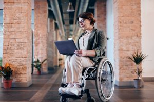 woman working on laptop in wheelchair