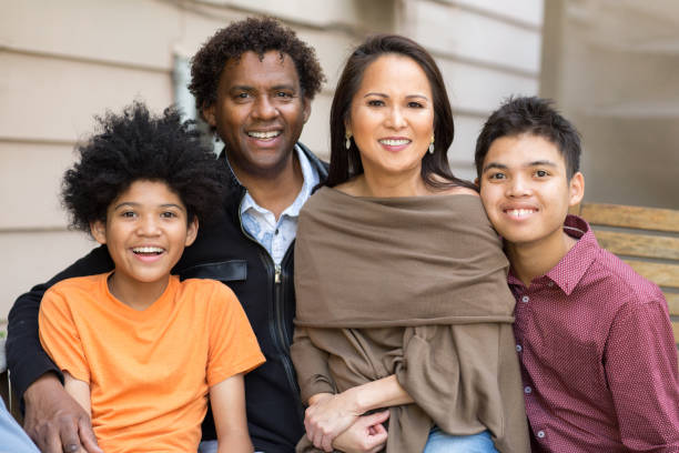 Happy family of four pose for a portrait